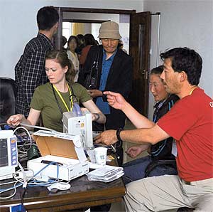 Michael Y. Young (red shirt) performs repairs during his Operation Smile mission in Yuxi, China.